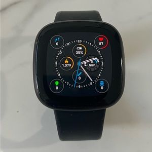 Fitbit Versa 3 smartwatch with charger